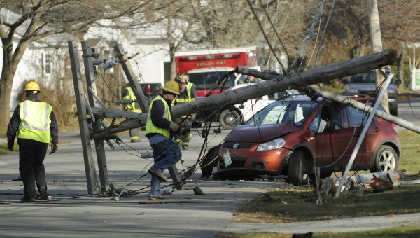 Electrical workers inspect a pole that was knocked over by a driver along 13th Street in Bangor on Tuesday, Nov. 27, 2012. The driver was handcuffed and taken from the scene by Bangor police. Electrical workers inspect a pole that was knocked over by a driver along 13th Street in Bangor on Tuesday, Nov. 27, 2012. The driver was handcuffed and taken from the scene by Bangor police.