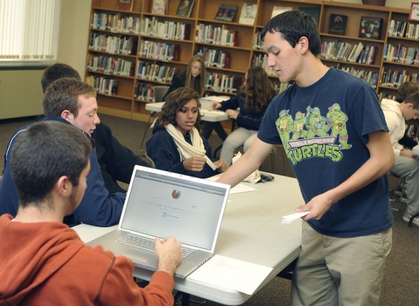 Student Ryan Loar, president of the Student Athletic Advisory Council at Brewer High School, hands out ballot slips to members of different committees on the council at their meeting Nov. 9. Student Ryan Loar, president of the Student Athletic Advisory Council at Brewer High School, hands out ballot slips to members of different committees on the council at their meeting Nov. 9.