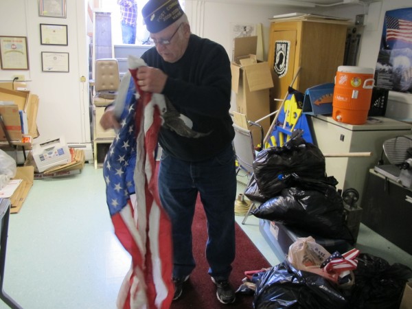 Louis Tonero, quartermaster for VFW Post 109 in Ellsworth, displays a worn flag at the VFW Hall in Ellsworth on Sunday. Louis Tonero, quartermaster for VFW Post 109 in Ellsworth, displays a worn flag at the VFW Hall in Ellsworth on Sunday.