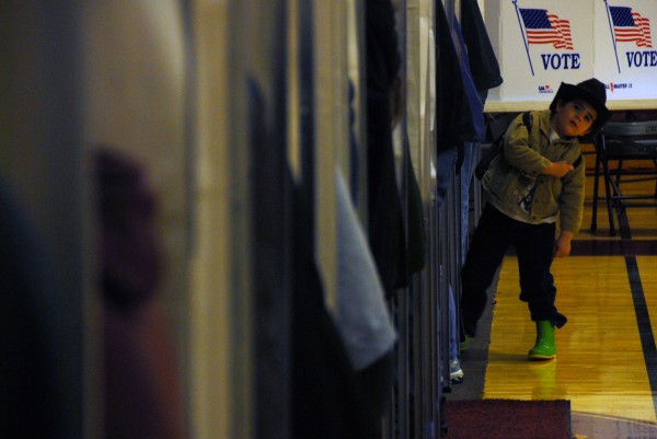 An unidentified boy whose mother is in a voting booth leans out and looks around at Mattanawcook Academy in Lincoln on Election Day, Nov. 6, 2012. An unidentified boy whose mother is in a voting booth leans out and looks around at Mattanawcook Academy in Lincoln on Election Day, Nov. 6, 2012.