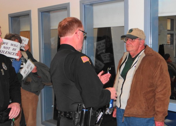 Ben Crimaudo (right) listens as Searsport Police Chief Dick LaHaye explains that Crimaudo can not return to the planning board meeting Wednesday night, Nov. 28, 2012. An officer removed Crimaudo from the meeting apparently for creating a disturbance. Ben Crimaudo (right) listens as Searsport Police Chief Dick LaHaye explains that Crimaudo can not return to the planning board meeting Wednesday night, Nov. 28, 2012. An officer removed Crimaudo from the meeting apparently for creating a disturbance.