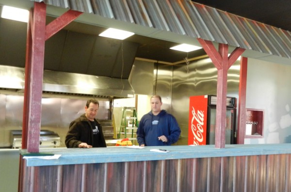 Keith Manaker (left) and Bob Cutler oversee the finishing touches at The Family Dog, a hot dog and burger restaurant they are opening soon at 6 Mill St. in Orono. The interior, designed by Chez Cherry, is meant to evoke a "casual, divey" kind of place. Keith Manaker (left) and Bob Cutler oversee the finishing touches at The Family Dog, a hot dog and burger restaurant they are opening soon at 6 Mill St. in Orono. The interior, designed by Chez Cherry, is meant to evoke a "casual, divey" kind of place.