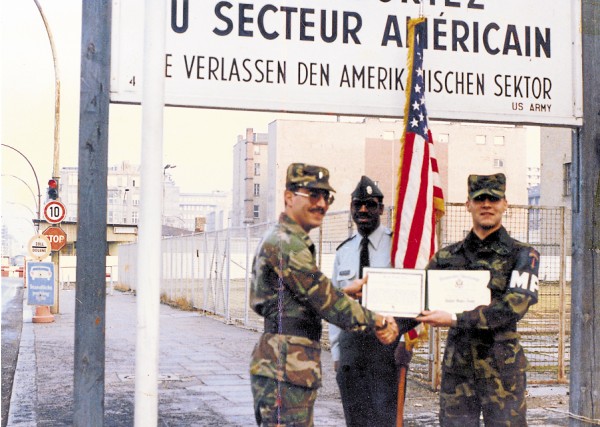 When the time came to re-enlist in the Army, military policeman Jesse Wilson II (right) did so in a ceremony held at Charlie Checkpoint separating West Berlin from East Berlin (background). According to Wilson, East German border guards watched in the distance as he re-enlisted right at the edge of the Berlin Wall. When the time came to re-enlist in the Army, military policeman Jesse Wilson II (right) did so in a ceremony held at Charlie Checkpoint separating West Berlin from East Berlin (background). According to Wilson, East German border guards watched in the distance as he re-enlisted right at the edge of the Berlin Wall.