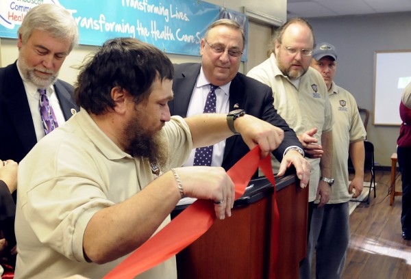 Unlimited Solutions Clubhouse member Robert "J.R." West (left) hands the red ribbon to Governor Paul LePage (center) during the opening ceremony of the new facility in Bangor. Governor LePage has been an avid supporter to create a network of these facilities in four Maine cities since the late 1990's. The facilities help people with mental illness to find jobs. Unlimited Solutions Clubhouse member Robert "J.R." West (left) hands the red ribbon to Governor Paul LePage (center) during the opening ceremony of the new facility in Bangor. Governor LePage has been an avid supporter to create a network of these facilities in four Maine cities since the late 1990's. The facilities help people with mental illness to find jobs.