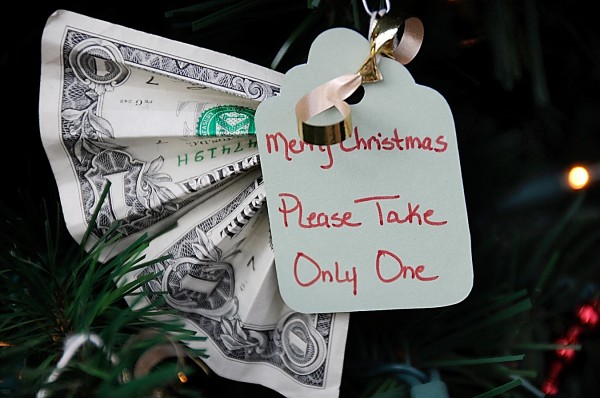 This dollar, along with other money donations, is clipped to the Bangor Elves' small holiday tree in downtown Bangor in December 2011. This dollar, along with other money donations, is clipped to the Bangor Elves' small holiday tree in downtown Bangor in December 2011.