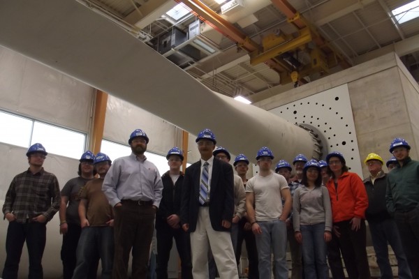 Habib Dagher, director of the UMaine Advanced Structures and Composites Center (front right), and Jake Ward, assistant vice president for research, economic development and governmental relations at UMaine (front left), stand with members of deep water offshore wind energy development team stand under a 121-foot turbine blade undergoing stress testing at the UMaine research facility on Friday, Dec. 7. Habib Dagher, director of the UMaine Advanced Structures and Composites Center (front right), and Jake Ward, assistant vice president for research, economic development and governmental relations at UMaine (front left), stand with members of deep water offshore wind energy development team stand under a 121-foot turbine blade undergoing stress testing at the UMaine research facility on Friday, Dec. 7.