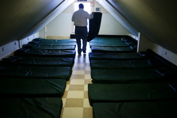 Josh O'Brien, director of Portland's Oxford Street Shelter, moves and checks mats on the third floor Wednesday Dec. 12, 2012, during his daily walk through the facility. The third floor alone has enough beds to consider it the largest dry shelter in the state. Josh O'Brien, director of Portland's Oxford Street Shelter, moves and checks mats on the third floor Wednesday Dec. 12, 2012, during his daily walk through the facility. The third floor alone has enough beds to consider it the largest dry shelter in the state.