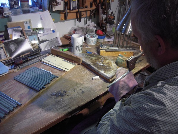 Bright beads of solder float on a flat slab of marble as Stephen Boody of New Sweden seals the fine seam on one of 256 pipes he is making for a pipe organ to be installed in North Carolina. Bright beads of solder float on a flat slab of marble as Stephen Boody of New Sweden seals the fine seam on one of 256 pipes he is making for a pipe organ to be installed in North Carolina.