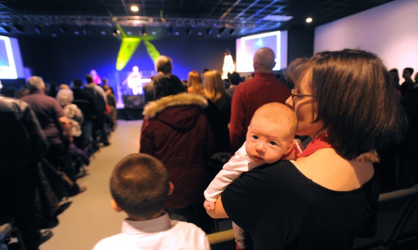 Renee Moran of Brewer holds her eight-week-old daughter, Casey, during the Christmas Eve service at the Rock Church in Bangor Monday. Renee Moran of Brewer holds her eight-week-old daughter, Casey, during the Christmas Eve service at the Rock Church in Bangor Monday.