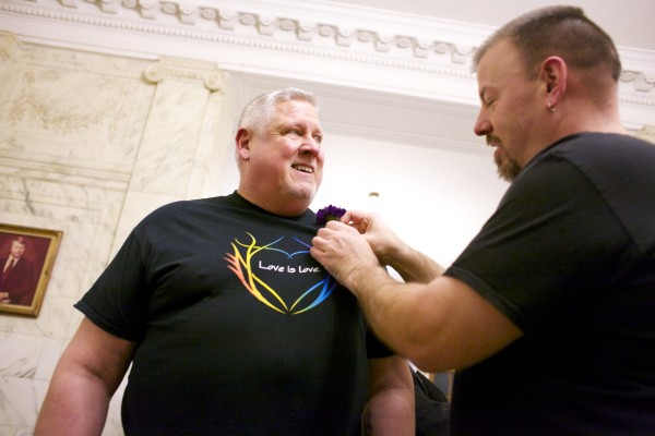 Michael Snell (left) receives a boutonniere from Steven Bridges before waiting in line to get married at Portland City Hall Friday evening. Michael Snell (left) receives a boutonniere from Steven Bridges before waiting in line to get married at Portland City Hall Friday evening.