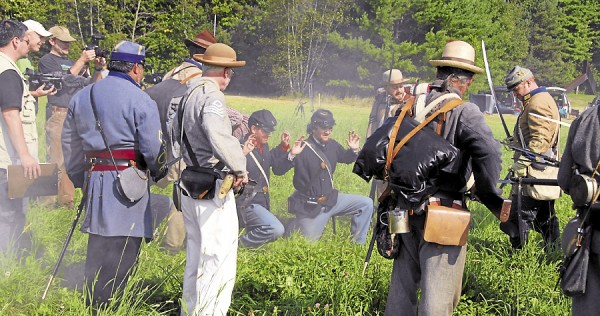 Maine Public Broadcasting Network Art Director and Producer Dan Lambert (far left) watches as two Union soldiers surrender to Confederate infantrymen at Good Will Hinckley School in Fairfield on Aug. 25, 2012. Lambert and a camera crew filmed the scene for inclusion in the MPBN documentary titled "16th Maine at Gettysburg." Among the other MPBN staffers working that day was videographer Chad Diamond (third from the left). Maine Public Broadcasting Network Art Director and Producer Dan Lambert (far left) watches as two Union soldiers surrender to Confederate infantrymen at Good Will Hinckley School in Fairfield on Aug. 25, 2012. Lambert and a camera crew filmed the scene for inclusion in the MPBN documentary titled "16th Maine at Gettysburg." Among the other MPBN staffers working that day was videographer Chad Diamond (third from the left).