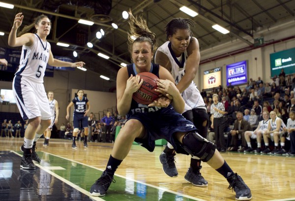 Rhode Island's Megan Straumann and Maine's Chantel Charles battle for a loose ball in the second half at the Portland Expo on Saturday, Dec. 8, 2012, in Portland. Rhode Island's Megan Straumann and Maine's Chantel Charles battle for a loose ball in the second half at the Portland Expo on Saturday, Dec. 8, 2012, in Portland.