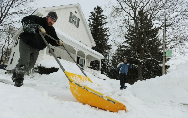 Matt LeClair (left) and his roommate John Kotredes (right) shovel and scoop the snow from Saturday's storm from their driveway and sidewalk along Savage Street in Bangor on Sunday. Matt LeClair (left) and his roommate John Kotredes (right) shovel and scoop the snow from Saturday's storm from their driveway and sidewalk along Savage Street in Bangor on Sunday.