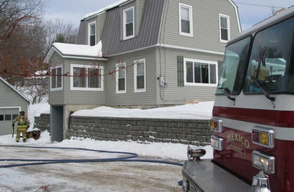 Rumford fire Lt. Keith Bickford, left, carries charred boards from stairs that caught fire late Thursday morning while the owner of 50 Cross St. in Mexico was trying to thaw frozen pipes with a kerosene heater in the basement, Mexico firefighters said. Rumford fire Lt. Keith Bickford, left, carries charred boards from stairs that caught fire late Thursday morning while the owner of 50 Cross St. in Mexico was trying to thaw frozen pipes with a kerosene heater in the basement, Mexico firefighters said.