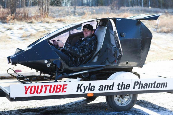 Kyle Anderson is pictured here with The Phantom, a fully enclosed snowmobile that he designed and built. The 26-year-old spent $1,500 manufacturing the machine with parts that he made or found. It has a heater, CD player, rearview TV monitor and an Indy 500 motor. Anderson is planning to take the snowmobile on a tour across the U.S. to generate investor interest in the mass production of his invention. Kyle Anderson is pictured here with The Phantom, a fully enclosed snowmobile that he designed and built. The 26-year-old spent $1,500 manufacturing the machine with parts that he made or found. It has a heater, CD player, rearview TV monitor and an Indy 500 motor. Anderson is planning to take the snowmobile on a tour across the U.S. to generate investor interest in the mass production of his invention.