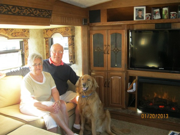 Donna and George sit with their dog, Captain, in their "rolling home," a fifth wheel RV that hitches to the bed of their pickup truck. Donna and George sit with their dog, Captain, in their "rolling home," a fifth wheel RV that hitches to the bed of their pickup truck.