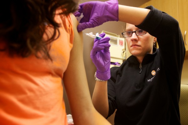 Certified Registered Medical Assistant Shannon Martin administers a flu shot to a 12-year-old girl at a Martin's Point Healthcare pediatric flu clinic in Portland on Friday Jan. 11, 2013. Certified Registered Medical Assistant Shannon Martin administers a flu shot to a 12-year-old girl at a Martin's Point Healthcare pediatric flu clinic in Portland on Friday Jan. 11, 2013.