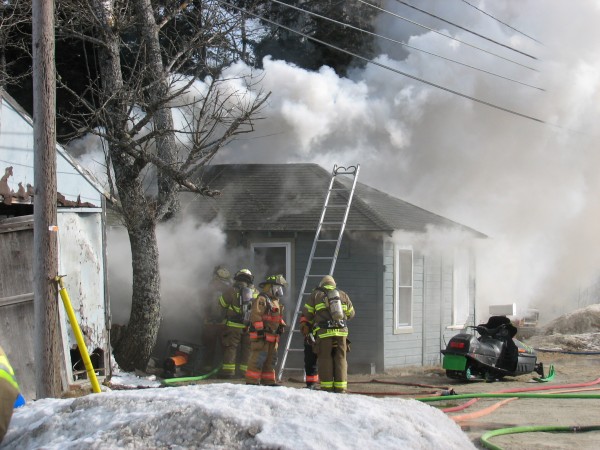 Firefighters stand outside a burning home Thursday, Jan. 24, 2013, on Route 1 in Sullivan. No one was injured in the blaze, which may have been caused when the resident tried to thaw out some frozen pipes, but the highway was closed to traffic for about four hours while firefighters tired to put out the flames. Firefighters stand outside a burning home Thursday, Jan. 24, 2013, on Route 1 in Sullivan. No one was injured in the blaze, which may have been caused when the resident tried to thaw out some frozen pipes, but the highway was closed to traffic for about four hours while firefighters tired to put out the flames.
