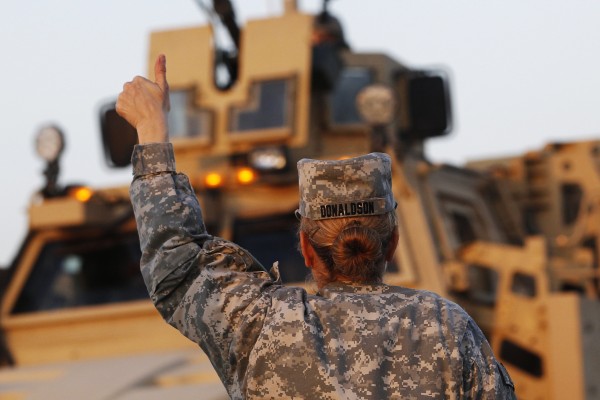 U.S. Army convoys are given a thumb up from a female soldier after crossing into Kuwait during the last convoy out of Iraq on Dec. 18, 2011. Defense Secretary Leon Panetta has decided to lift the military's ban on women serving in front-line combat, a move that could open thousands of warfighting jobs to female service members, a senior U.S. defense official said. U.S. Army convoys are given a thumb up from a female soldier after crossing into Kuwait during the last convoy out of Iraq on Dec. 18, 2011. Defense Secretary Leon Panetta has decided to lift the military's ban on women serving in front-line combat, a move that could open thousands of warfighting jobs to female service members, a senior U.S. defense official said.