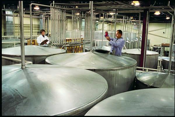 Workers at White Rock Distilleries in Lewiston inspect some of their product. Workers at White Rock Distilleries in Lewiston inspect some of their product.