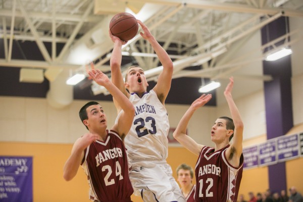 Hampden Academy's Zachary Gilpin (center) splits Bangor defenders Matt Cosgrove (left) and Sean Tocci (right) on Friday, Jan. 18, 2013. Hampden Academy's Zachary Gilpin (center) splits Bangor defenders Matt Cosgrove (left) and Sean Tocci (right) on Friday, Jan. 18, 2013.