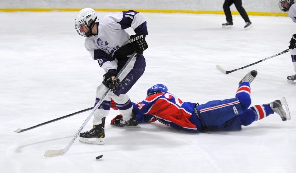 Messalonskee High School's Tyler Simpson (right) falls on the ice as he battles for the puck with Hampden Academy's Dylan Cray during the second period of the game in Brewer Wednesday. Messalonskee High School's Tyler Simpson (right) falls on the ice as he battles for the puck with Hampden Academy's Dylan Cray during the second period of the game in Brewer Wednesday.