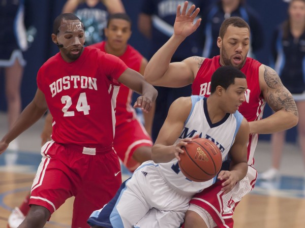 Maine Men's basketball player Justin Edwards (14) drives around BU players Travis Robinson (24) and Dom Morris (15) in the first half of an NCAA college basketball game in Orono on Wednesday, Jan. 2, 2013. Maine Men's basketball player Justin Edwards (14) drives around BU players Travis Robinson (24) and Dom Morris (15) in the first half of an NCAA college basketball game in Orono on Wednesday, Jan. 2, 2013.
