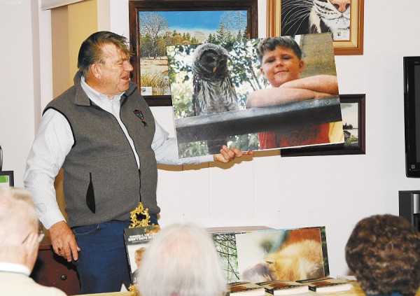 John Ford shows a photo of his son and one of the two owls he raised to the crowd at Sunbury Village Independent Living Community in Bangor last week. Ford is promoting his bestselling book, "Suddenly, the Cider Didn't Taste So Good," containing memorable, and often humorous, anecdotes of his time as a Maine game warden. John Ford shows a photo of his son and one of the two owls he raised to the crowd at Sunbury Village Independent Living Community in Bangor last week. Ford is promoting his bestselling book, "Suddenly, the Cider Didn't Taste So Good," containing memorable, and often humorous, anecdotes of his time as a Maine game warden.
