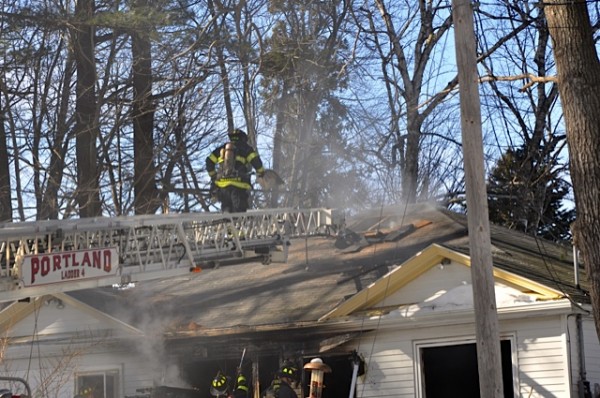 Portland firefighters battle a fire on Burnside Avenue on Sunday afternoon. Portland firefighters battle a fire on Burnside Avenue on Sunday afternoon.