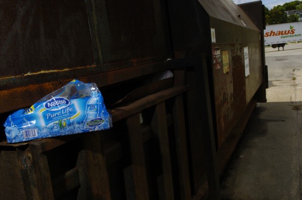 Bottled water packaging is wedged into a Dumpster behind the Shaw's supermarket on Main Street in Bangor in 2010. A pair of men were spotted there after purchasing several cases of bottled water with food assistance money and then emptying the bottles in this holding dock area behind the supermarket so they could redeem the empty bottles for deposit money. Bottled water packaging is wedged into a Dumpster behind the Shaw's supermarket on Main Street in Bangor in 2010. A pair of men were spotted there after purchasing several cases of bottled water with food assistance money and then emptying the bottles in this holding dock area behind the supermarket so they could redeem the empty bottles for deposit money.
