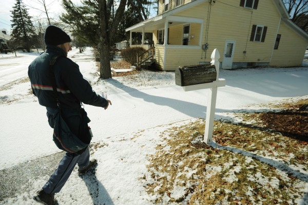 U.S. Postal Service letter carrier Scott Perkins delivers mail along 7th Street in Bangor on Wednesday, Feb. 6, 2013. The U.S. Postal Service plans to drop Saturday delivery of first-class mail by August 2013. Packages will still be delivered on Saturdays and post office hours are not expected to change. U.S. Postal Service letter carrier Scott Perkins delivers mail along 7th Street in Bangor on Wednesday, Feb. 6, 2013. The U.S. Postal Service plans to drop Saturday delivery of first-class mail by August 2013. Packages will still be delivered on Saturdays and post office hours are not expected to change.