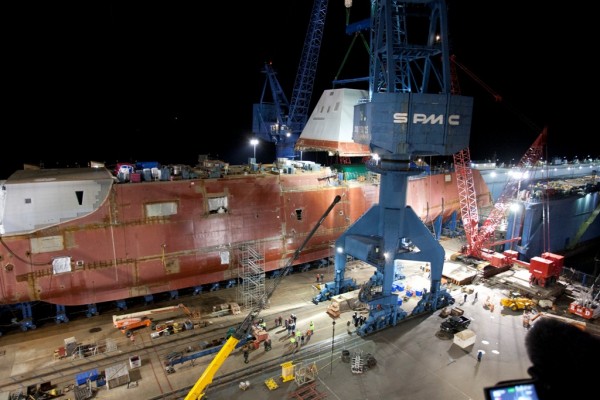 A 900-ton composite deckhouse of the DDG 1000 warship under construction at Bath Iron Works is hoisted onto to the hull of the ship on in December 2012 in Bath. A 900-ton composite deckhouse of the DDG 1000 warship under construction at Bath Iron Works is hoisted onto to the hull of the ship on in December 2012 in Bath.