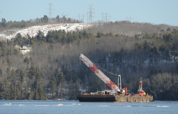 A barge carrying a crane to be used in the dismantling of the old Waldo Hancock Bridge in Prospect is pushed down the Penobscot River near Winterport on Tuesday. A barge carrying a crane to be used in the dismantling of the old Waldo Hancock Bridge in Prospect is pushed down the Penobscot River near Winterport on Tuesday.
