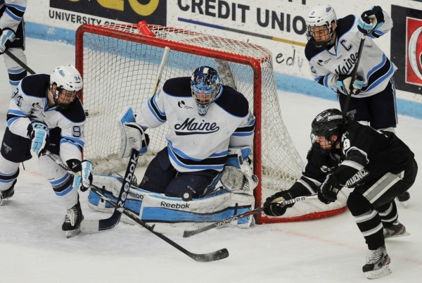 UMaine's Devin Shore helps UMaine goalie Martin Ouellette defend against Derek Army during second-period action at Orono on Friday, Feb. 1, 2013. UMaine's Mike Cornell is also in on the action. UMaine's Devin Shore helps UMaine goalie Martin Ouellette defend against Derek Army during second-period action at Orono on Friday, Feb. 1, 2013. UMaine's Mike Cornell is also in on the action.