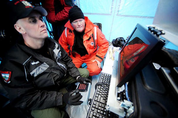 Maine Wardens Mike Joy (right) and Bruce Loring watch a screen as an underwater, remotely operated vehicle equipped with a camera searches Rangeley Lake for the bodies of Kenneth Henderson, 40, of China, Glen Henderson, 43, of Sabattus and John Spencer, 41, of Litchfield on Wednesday. The three snowmobilers have been missing since Dec. 30. Maine Wardens Mike Joy (right) and Bruce Loring watch a screen as an underwater, remotely operated vehicle equipped with a camera searches Rangeley Lake for the bodies of Kenneth Henderson, 40, of China, Glen Henderson, 43, of Sabattus and John Spencer, 41, of Litchfield on Wednesday. The three snowmobilers have been missing since Dec. 30.