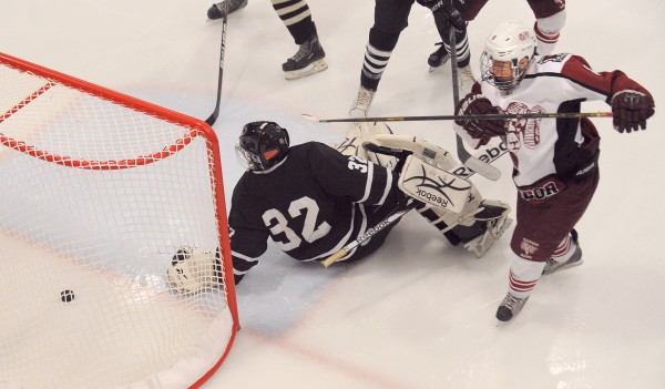 Bangor High School's Nick Graham (right) puts the puck in the net past Maranacook/Hall-Dale/Winthrop High School's goalie Tyler Plante during the second period of the game in Bangor Tuesday evening. Bangor High School's Nick Graham (right) puts the puck in the net past Maranacook/Hall-Dale/Winthrop High School's goalie Tyler Plante during the second period of the game in Bangor Tuesday evening.