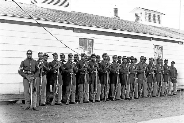Black soldiers assigned to Co. E, 4th United States Colored Troops, proudly form outside a barracks. As the Army created new black regiments, many Maine officers and non-commissioned officers sought promotion to the available officers' slots. Federal law stipulated that only white officers could command black soldiers. Black soldiers assigned to Co. E, 4th United States Colored Troops, proudly form outside a barracks. As the Army created new black regiments, many Maine officers and non-commissioned officers sought promotion to the available officers' slots. Federal law stipulated that only white officers could command black soldiers.