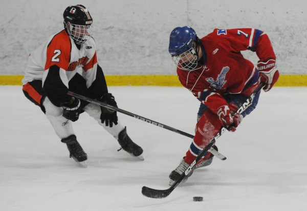 Brewer's Josh McNally gets his stick caught between the feet of Messalonskee's Jake Dexter as he skates the puck towards the goal during first period action at Brewer on Wednesday. Brewer's Josh McNally gets his stick caught between the feet of Messalonskee's Jake Dexter as he skates the puck towards the goal during first period action at Brewer on Wednesday.