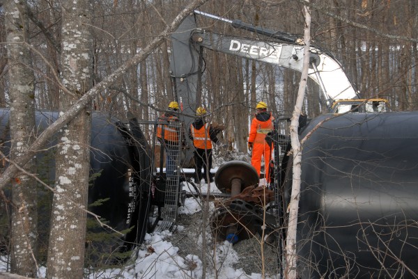 Workers from Pan Am Railways, the Maine Department of Environmental Protection and a contractor continued to work Friday, March 8, 2013, to pump oil from 13 oil tankers that tipped over the day before in Mattawamkeag. Workers from Pan Am Railways, the Maine Department of Environmental Protection and a contractor continued to work Friday, March 8, 2013, to pump oil from 13 oil tankers that tipped over the day before in Mattawamkeag.