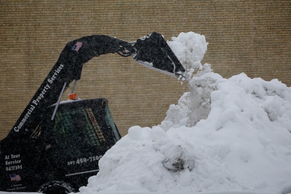 Workmen clear snow from a private parking lot on Myrtle Street on Sunday, Feb. 24, 2013, in Portland, making way for cars carrying people coming to the Portland Symphony Orchestra's "A Night at the Movies" pops concert. Workmen clear snow from a private parking lot on Myrtle Street on Sunday, Feb. 24, 2013, in Portland, making way for cars carrying people coming to the Portland Symphony Orchestra's "A Night at the Movies" pops concert.