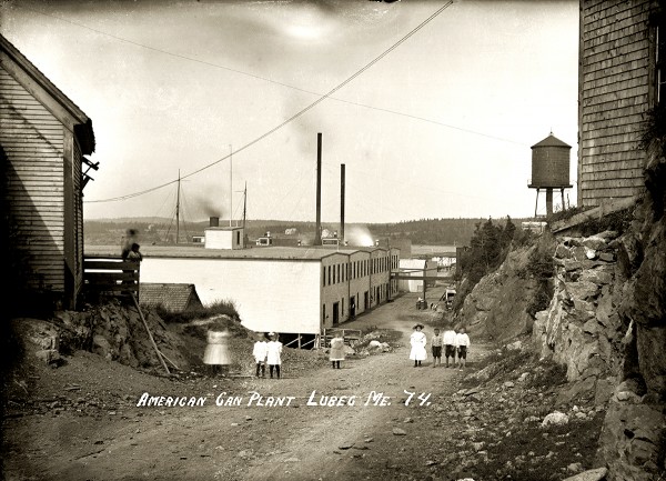 In this circa 1910 photograph, children pose near the American Can Company plant built in Lubec village after its North Lubec factory burned. The first mechanized "tin" can manufacturer in Lubec, it soon erected a much larger building, and those shown here became warehouses. In a few decades the company was turning out 350 million cans a year. Lubec and Eastport canneries employed many children, attracting the attention of well-known documentary photographer and social reformer Lewis Hine. In August 1911 he photographed young workers, many under the age of 12, cutting and packing fish in local canneries. In this circa 1910 photograph, children pose near the American Can Company plant built in Lubec village after its North Lubec factory burned. The first mechanized "tin" can manufacturer in Lubec, it soon erected a much larger building, and those shown here became warehouses. In a few decades the company was turning out 350 million cans a year. Lubec and Eastport canneries employed many children, attracting the attention of well-known documentary photographer and social reformer Lewis Hine. In August 1911 he photographed young workers, many under the age of 12, cutting and packing fish in local canneries.