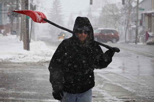 Mark Jackson trudges down Congress Street in Portland on Tuesday, shovel in hand, during the last snowstorm of the winter. Jackson clears snow for a about a dozen clients in the city as a sideline job. Mark Jackson trudges down Congress Street in Portland on Tuesday, shovel in hand, during the last snowstorm of the winter. Jackson clears snow for a about a dozen clients in the city as a sideline job.