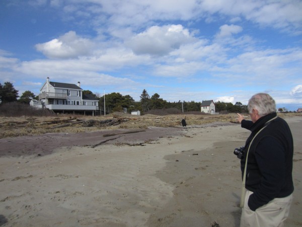 Fred Hill points to the area northeast of his family's cottage where homes fell into the sea during the winter of 1976. Hill's family raised their home — at the time a single-story ranch — onto telephone poles to keep the house from getting swept out to sea. Fred Hill points to the area northeast of his family's cottage where homes fell into the sea during the winter of 1976. Hill's family raised their home — at the time a single-story ranch — onto telephone poles to keep the house from getting swept out to sea.