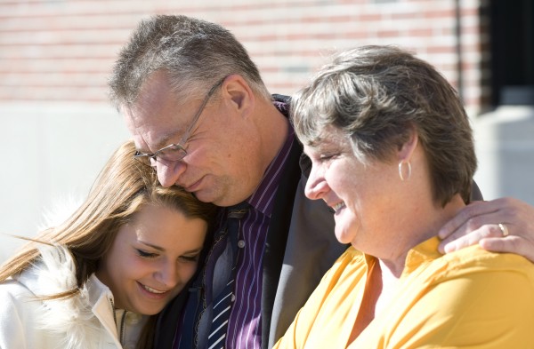 Lexi Henkel (from left) gets a hug from her father, Norbert, as they and Lexi's mother, Judy, talk to the media outside the Penobscot Judicial Center in Bangor on Tuesday. Lexi Henkel (from left) gets a hug from her father, Norbert, as they and Lexi's mother, Judy, talk to the media outside the Penobscot Judicial Center in Bangor on Tuesday.