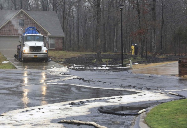 Men wearing protective clothing survey cleanup efforts March 30, 2013, where an underground crude oil pipeline ruptured in the Northwood subdivision in Mayflower, Ark. Exxon Mobil was working to clean up thousands of barrels of oil after the pipeline ruptured, causing 22 homes to be evacuated in the area. The Pegasus pipeline, which carries Canadian crude oil from Pakota, Ill., to Nederland, Texas, was shut-off Friday after the leak was discovered, the company said in a statement. Men wearing protective clothing survey cleanup efforts March 30, 2013, where an underground crude oil pipeline ruptured in the Northwood subdivision in Mayflower, Ark. Exxon Mobil was working to clean up thousands of barrels of oil after the pipeline ruptured, causing 22 homes to be evacuated in the area. The Pegasus pipeline, which carries Canadian crude oil from Pakota, Ill., to Nederland, Texas, was shut-off Friday after the leak was discovered, the company said in a statement.