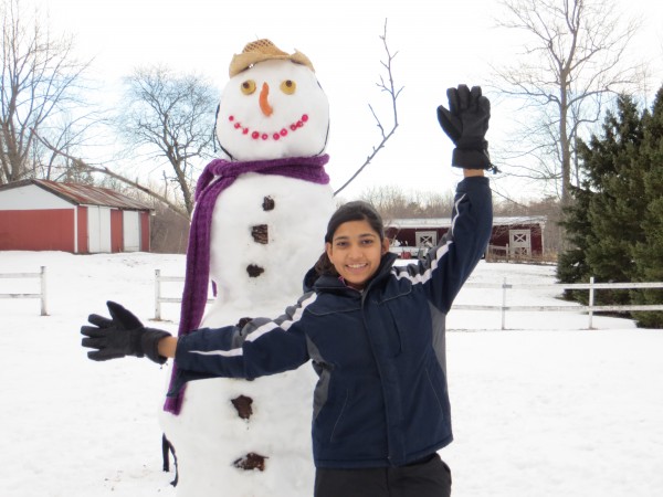 Aqsa Munir, an exchange student from Pakistan spending the year in Hampden, Maine poses with her first-ever snowman. Aqsa Munir, an exchange student from Pakistan spending the year in Hampden, Maine poses with her first-ever snowman.