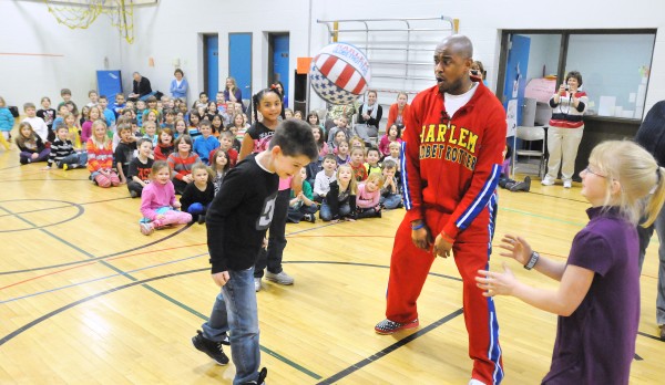 Harlem Globetrotter Scooter Christensen (second from right) teaches kids at the Abraham Lincoln School a Globetrotter trick after he spoke them them about bullying. Christensen is among the players who speak at schools about "The ABCs of Bullying Prevention," Harlem Globetrotter Scooter Christensen (second from right) teaches kids at the Abraham Lincoln School a Globetrotter trick after he spoke them them about bullying. Christensen is among the players who speak at schools about "The ABCs of Bullying Prevention,"