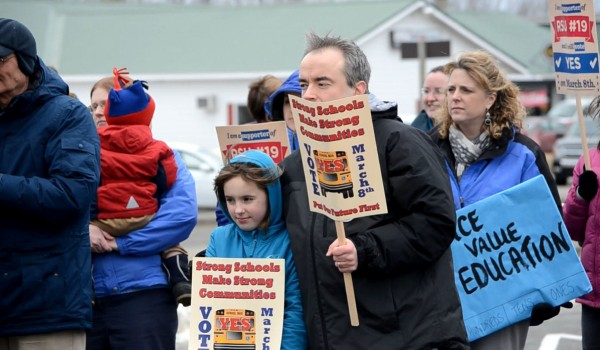 Chad Stratton (center) an RSU 19 school board member from Corinna, wraps his arm around his 10-year-old daughter, Onica, at a rally to support the $2.8 million loan requested by RSU 19 at Sawyer's Dairy Bar in Newport on Wednesday, March 6, 2013. Chad Stratton (center) an RSU 19 school board member from Corinna, wraps his arm around his 10-year-old daughter, Onica, at a rally to support the $2.8 million loan requested by RSU 19 at Sawyer's Dairy Bar in Newport on Wednesday, March 6, 2013.