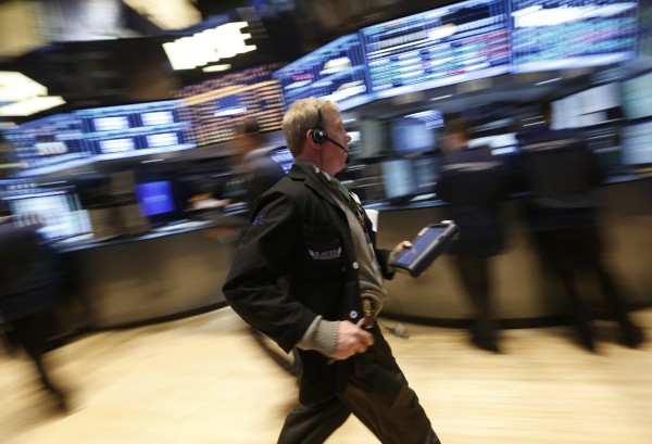 A trader rushes across the floor of the New York Stock Exchange on March 12, 2013. A trader rushes across the floor of the New York Stock Exchange on March 12, 2013.