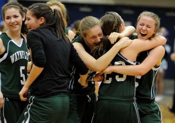 The Waynflete Flyers celebrate their 59-55 victory over Calais in the Class C girls state championship game at the Bangor Auditorium Saturday night. The Waynflete Flyers celebrate their 59-55 victory over Calais in the Class C girls state championship game at the Bangor Auditorium Saturday night.
